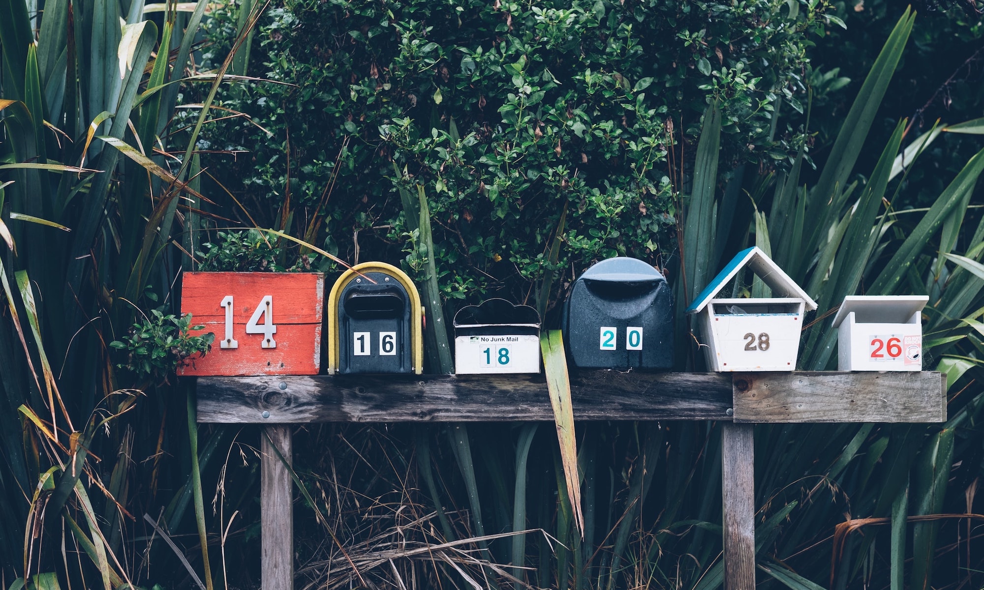 Six mailboxes that represent mail art being sent and received,